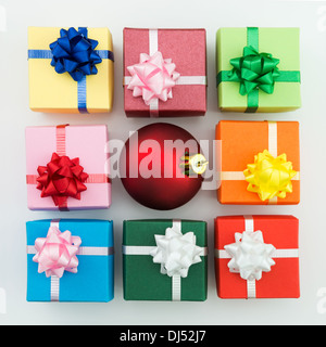 Multi color gift boxes and Christmas bauble Stock Photo
