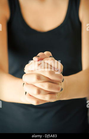 Hands of christian woman praying Stock Photo