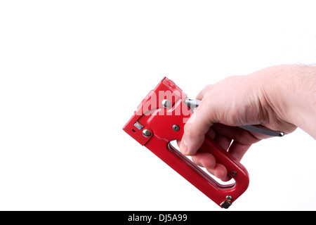 Construction stapler in a hand, isolated on a white background Stock Photo