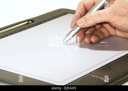 Hand with pen and graphics tablet Stock Photo