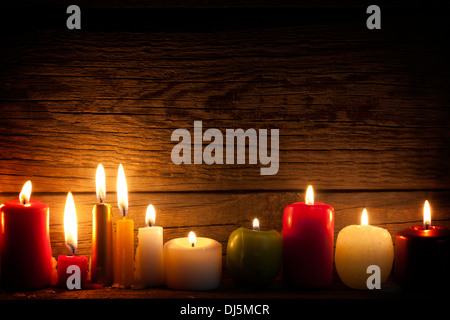 Candles in night in christmas mood on vintage wooden boards Stock Photo