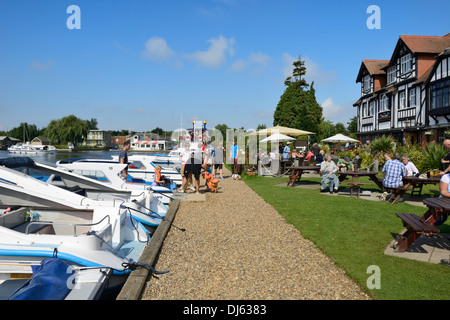 Boats moored on the river Bure beside the Swan Public House and restaurant, Horning, Norfolk, England, United Kingdom, UK,Europe Stock Photo