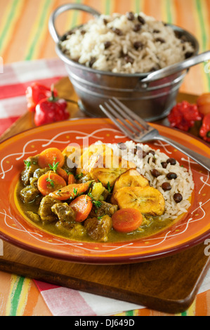 Curry goat with rice and gungo peas. Jamaica Food Stock Photo