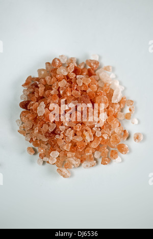 Himalayan pink salt on white background. Stock Photo