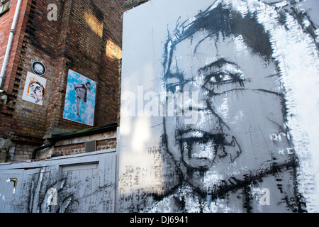 Mural street art by Guy Denning - portrait of woman in white scarf with ...