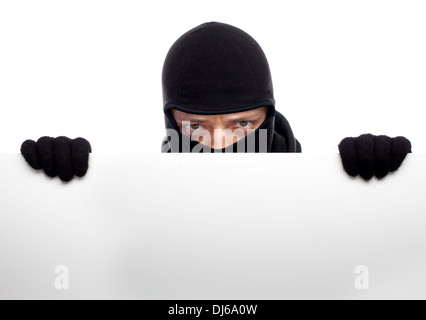 Robber hiding behind a empty white  space for text Stock Photo