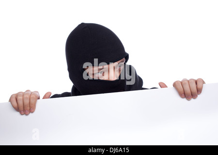 Robber hiding behind a empty white  space for text Stock Photo