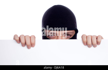 Robber hiding behind a empty white  space for text Stock Photo