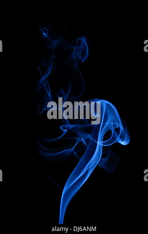 Blue smoke on the black background. Smooth waves of smoke. Stock Photo