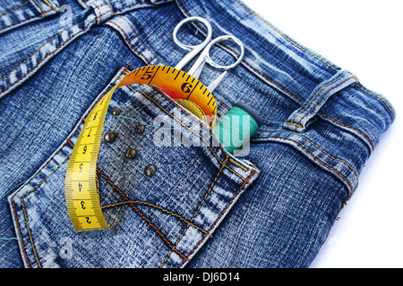 Tools in blue jeans pocket on white background. Stock Photo