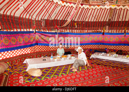 Tourists dining in a yurt, Ayaz Kala Yurt Camp, Ayaz Kala, Khorezm, Uzbekistan Stock Photo