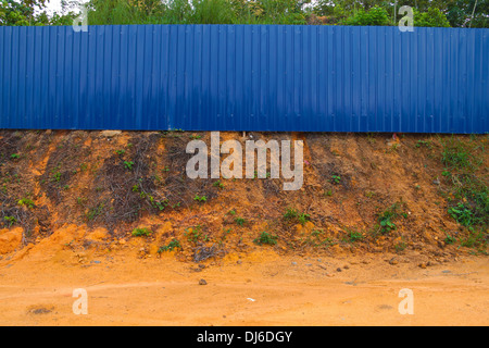 Blue fence to prevent unauthorised intrusion. Stock Photo