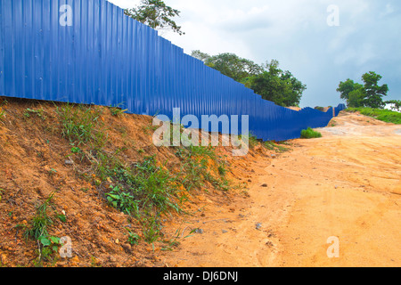 Blue fence to prevent unauthorised intrusion. Stock Photo