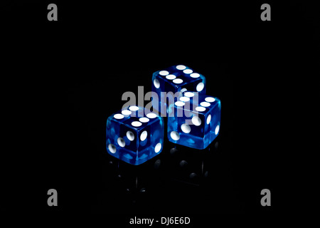 Three blue casino dice on a black background Stock Photo