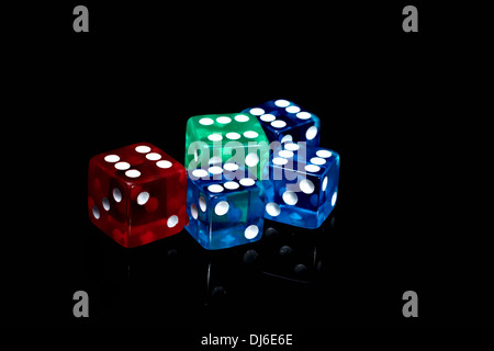 Five colour casino dice on a black background Stock Photo
