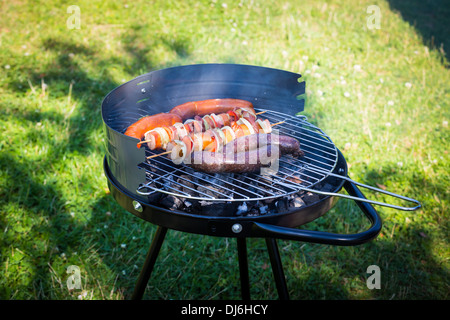 BBQ with fiery sausages on the grill Stock Photo