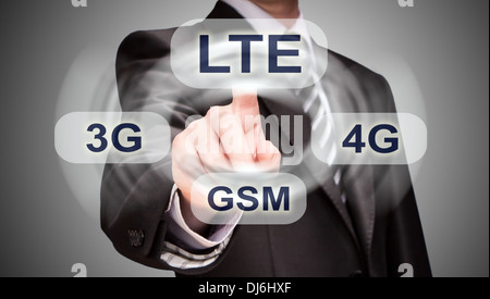 businessman is pushing his finger on lte button Stock Photo