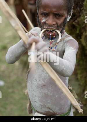 Child archer of Kamusi Short Dware Singsing Group Goroka District, Eastern Highlands Province - Goroka Show, Papua New Guinea Stock Photo