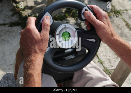 Man Holding Saitek Steering Wheel For Xbox Game Console Stock Photo