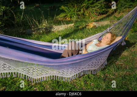 Woman enjoying rest in hammock Stock Photo