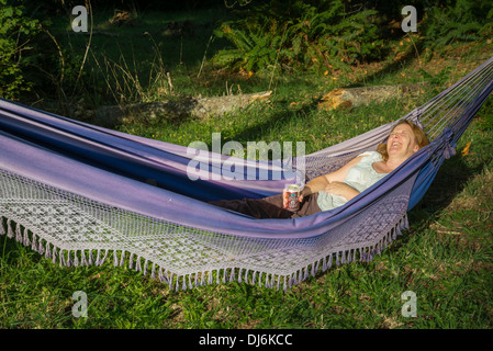 Woman enjoying rest in hammock Stock Photo