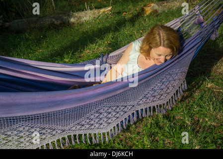 Woman enjoying rest in hammock Stock Photo