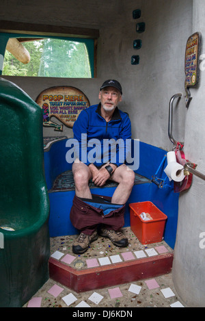 Man using compost toilet, Hornby Island, British Columbia, Canada Stock Photo