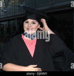 London England Portrait Of Young Woman At Graduation Wearing Mortar Board And Graduation Gown Stock Photo