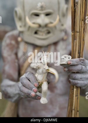 Mudman with mudman toy - Asaro Mudmen Singsing Group, Daulo District, Eastern Highlands Province - Goroka Show Papua New Guinea Stock Photo