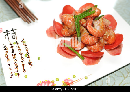 Stir-fried flowering Chinese chives with prawns and carrot Stock Photo