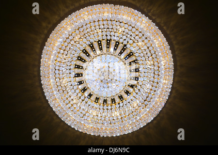 Contemporary glass chandelier hanging on the ceiling Stock Photo