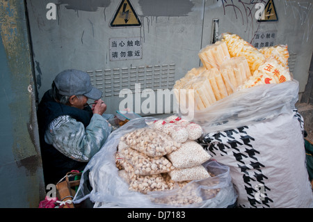Old woman selling snacks on street in Beijing, China Stock Photo