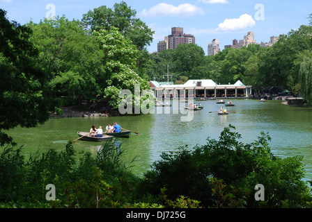 Rowing boats on the lake in Central Park, New York, looking towards the Loeb Boathouse restaurant. Stock Photo