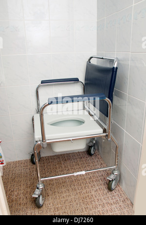 A Commode for a disabled person with wheels used for toileting & in the shower Stock Photo