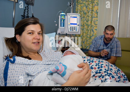 Woman Holding Her Newborn Baby in the Hospital Stock Photo