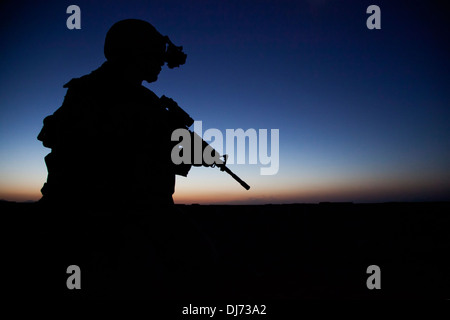 US Navy SEAL team special operations commando provides security during a night mission July 3, 2013 in Helmand province, Afghanistan. Stock Photo