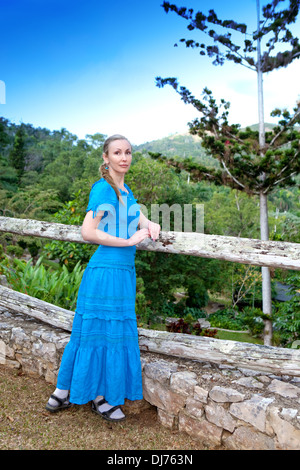 Cuba. The beautiful woman in a blue dress in park of Soroa (Jardin Botanico Orquideario Soroa) Stock Photo