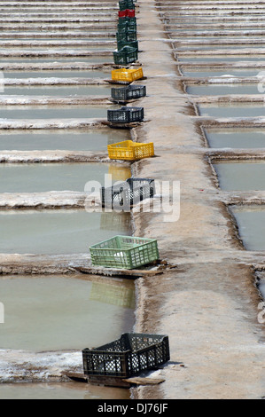 Salt pans ditches for premium quality sea salt situated on the Atlantic coastline within the protected 'Ria Formosa' and “Sapal de Castro Marim' nature reserves near the town of Tavira in Algarve the southernmost region of Portugal Stock Photo