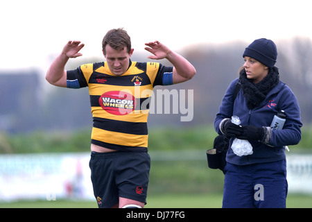 a physiotherapist attends an injured rugby player Stock Photo
