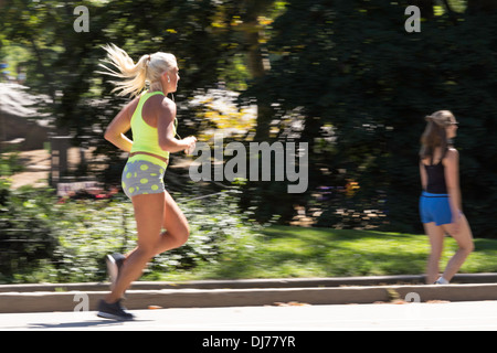 Young Fit Blond haired Woman Running , Central Park, NYC, USA Stock Photo