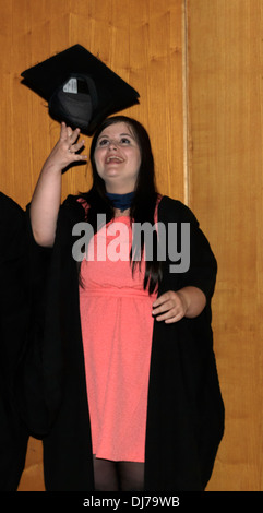 London England Young Woman Throwing Mortar Board in Air After Graduating Stock Photo