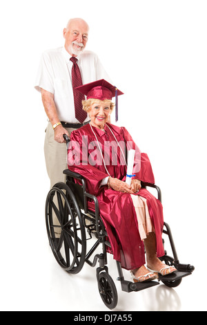 Senior couple. The husband is pushing his wife in a wheelchair. She just graduated college. Full body isolated on white. Stock Photo