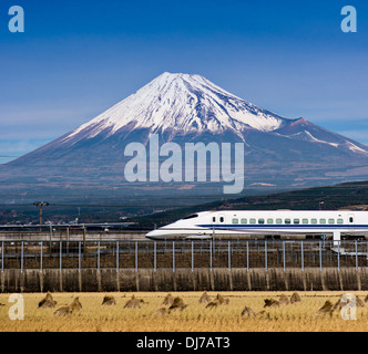 Bullet train passes below Mt. Fuji in Japan Stock Photo
