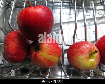 Health freshly washed red apples on a drainer An Apple A Day keeps the Doctor Away Stock Photo