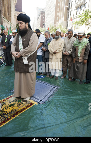 Annual Muslim Day Parade, New York City, 2012. Men praying on Madison Ave. before start of the parade. Stock Photo