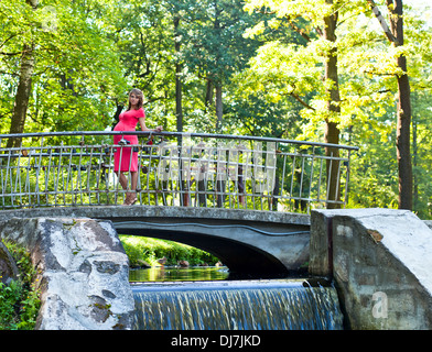 Pregnant woman on a walk bridge in the woods Stock Photo - Alamy