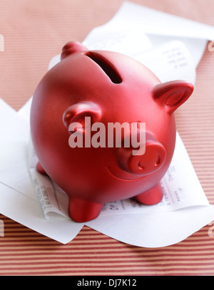 funny red Pig Piggy with lots of receipt - saving concept Stock Photo