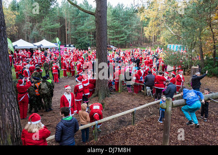 Hundreds of fund-raisers dressed as Santas run in the annual 'Santa Dash' to raise money for the Thames Hospice charity. Swinley Forest, Bracknell, Berkshire, England, GB, UK Stock Photo