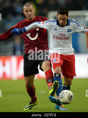 Hamburg, Germany. 24th Nov, 2013. Hamburg's Hakan Calhanoglu (R) vies for the ball with Hanover's Leon Andreasen during the German Bundesliga match between Hamburger SV and Hannover 96 at Imtech Arena in Hamburg, Germany, 24 November 2013. Photo: PETER STEFFEN (ATTENTION: Due to the accreditation guidelines, the DFL only permits the publication and utilisation of up to 15 pictures per match on the internet and in online media during the match.)/dpa/Alamy Live News Stock Photo