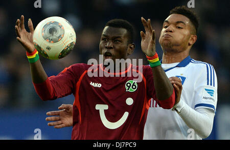 Hamburg, Germany. 24th Nov, 2013. Hamburg's Jonathan Tah (R) vies for the ball with Hanover's Mame Diouf during the German Bundesliga match between Hamburger SV and Hannover 96 at Imtech Arena in Hamburg, Germany, 24 November 2013. Photo: PETER STEFFEN (ATTENTION: Due to the accreditation guidelines, the DFL only permits the publication and utilisation of up to 15 pictures per match on the internet and in online media during the match.)/dpa/Alamy Live News Stock Photo